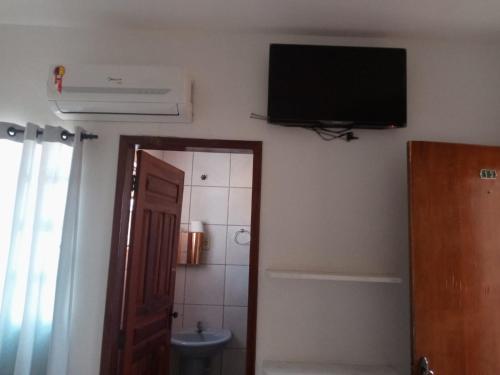邦热苏斯-达拉帕Pousada Algaroba的一间墙上配有电视的浴室和一个卫生间