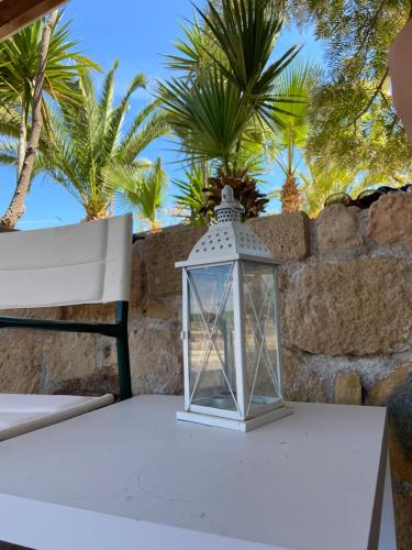 VathíPistachio Guesthouse, Παραδοσιακός ξενώνας的桌子上的灯笼,背后是棕榈树