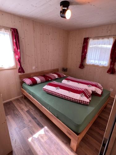 波斯基亚沃Bungalow Li Presi in Camping Cavresc, Via dal Cavresc 1, 7746 Le Prese-Poschiavo的一间卧室,配有两张床