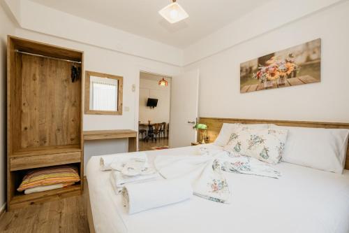 格克切达镇Azra Apart & Otel的卧室配有白色的床和木门