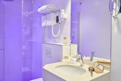 安锡阿讷西卡尔顿贝斯特韦斯特酒店的紫色浴室设有水槽和淋浴