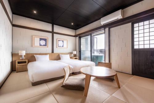 由布市Yufudake Ichibo no Yado Kirara的一间卧室配有一张大床和一张桌子