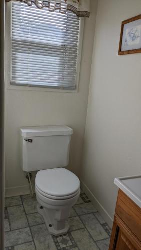 MiramonteApple Place Room #1的一间带白色卫生间的浴室和窗户。