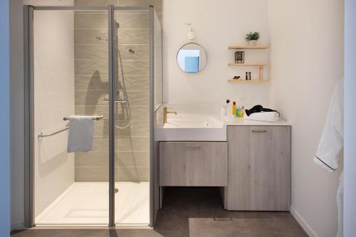 瓦讷DOMITYS - Manoir Maison Douaud的带淋浴、盥洗盆和卫生间的浴室