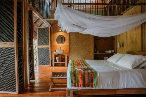 RincónDos Aguas Lodge的一间卧室配有一张带蚊帐的床