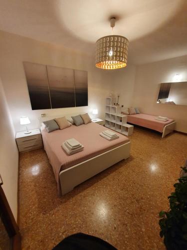 马格拉12 minuti da Venezia appartamento con parcheggio的一间卧室配有一张大床和一个吊灯。