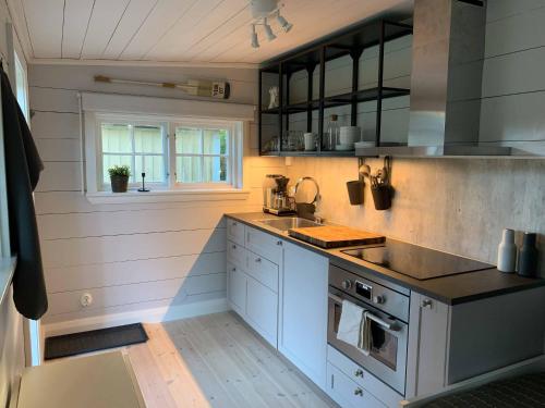 卡尔马Mysigt gårdshus på vackra Stensö的厨房配有水槽和炉灶