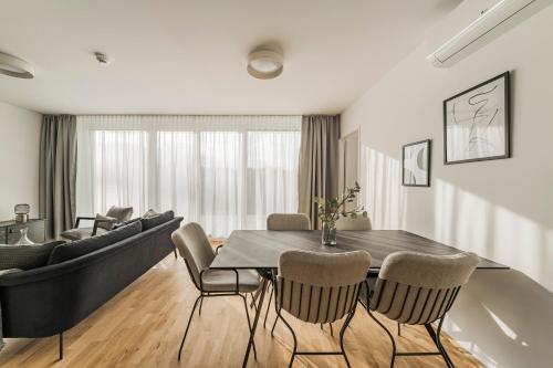 维也纳Arbio I Liv's Place Lux Apartments的客厅设有餐桌和沙发