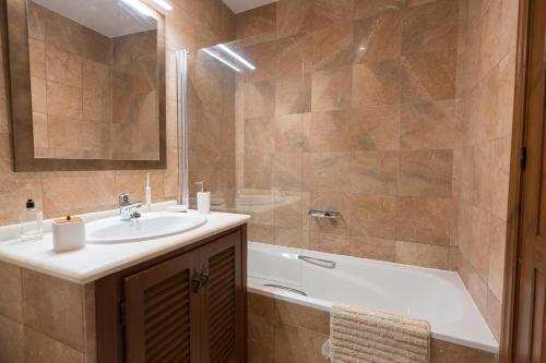 拉海瑞德拉Blue Charme的浴室配有盥洗盆和浴缸。
