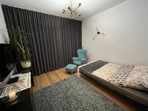 琴斯托霍瓦Przytulny Apartament w Centrum的卧室配有床、椅子和窗户。