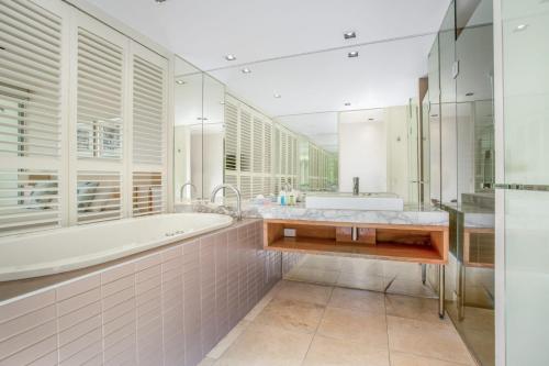 彩虹海滩Unit 8 Plantation Resort Rainbow Beach的白色的浴室设有浴缸和水槽。