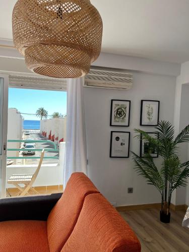 拉斯内格拉斯Las Negras的客厅配有橙色沙发和吊灯。