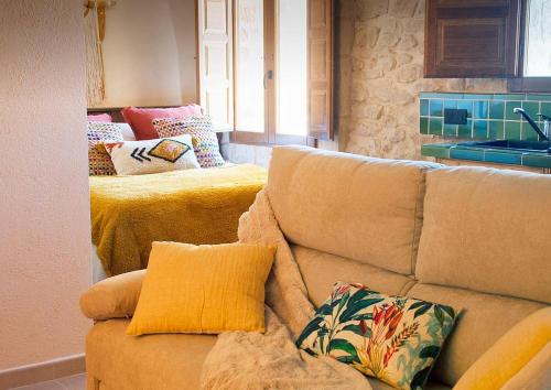 Torre del ComptePrecioso loft rural con estufa de leña panorámica的客厅配有带枕头的沙发