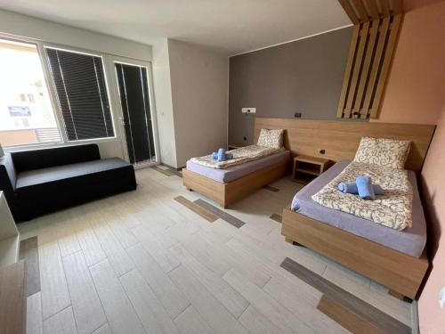 大格拉迪什泰Siesta Srebrno Jezero的大房间设有两张床和一张沙发