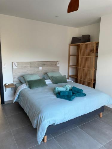 乌韦兹河畔莫朗À mont nos hôtes 2的一间卧室配有一张带蓝色床单的大床