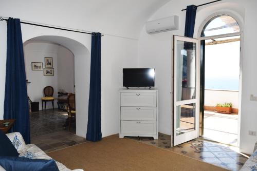 卡普里La Terrazza Apartment的一间带镜子和电视的客厅
