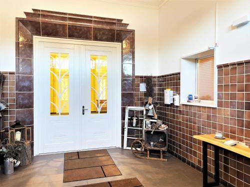 LaubuschIBS Begegnungszentrum的浴室设有白色门和彩色玻璃窗