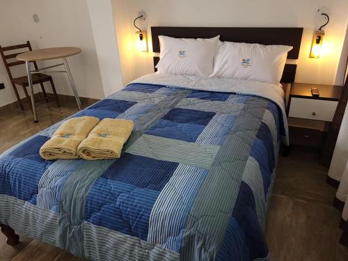 奇卡马港TUPANANCHIKAMA的一张蓝色和白色的床,上面有两条毛巾
