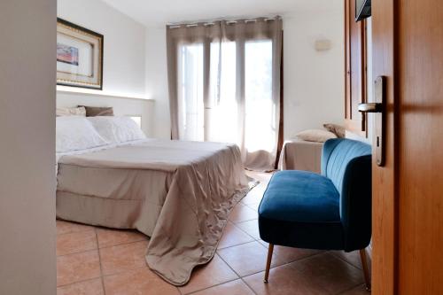 阿利米尼Missipezza Residence a Frassanito的卧室配有床、椅子和窗户。