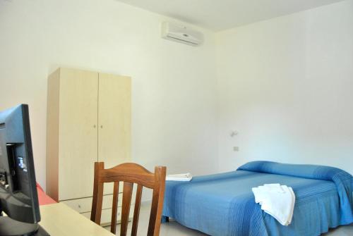 里卡迪赛拉乌纳沃尔塔公寓式酒店的一间卧室配有一张床、一张书桌和一台电视。