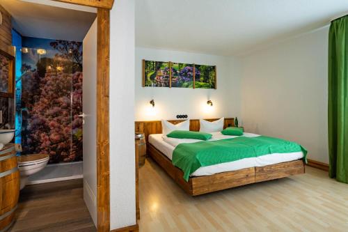 吕本瑙Die GURKENSCHEUNE - Frühstückspension的一间带绿色床的卧室和一间浴室