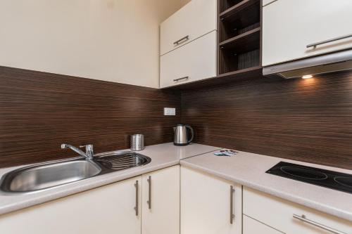 华沙Al Krakowska 291A by Homeprime的厨房配有白色橱柜和水槽
