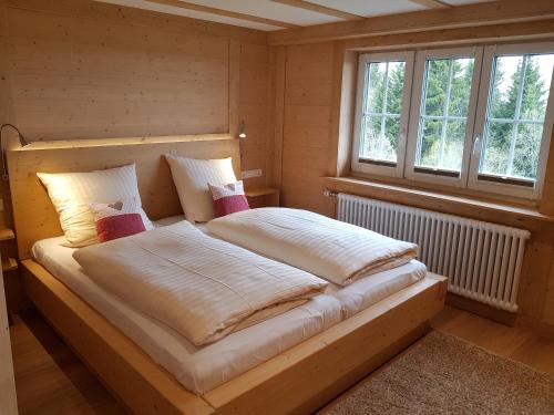 黑林山区邦多夫Ferienwohnung Waldrauschen in der Höhenpension Glashütte的一张大床,房间带两个枕头