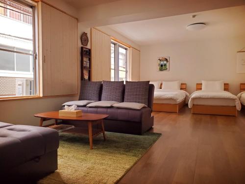 东京客房旅馆的客厅配有沙发和1张床