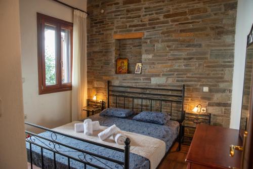 扎戈拉Notas Pelion Seaview Villa的一间卧室配有一张石墙床