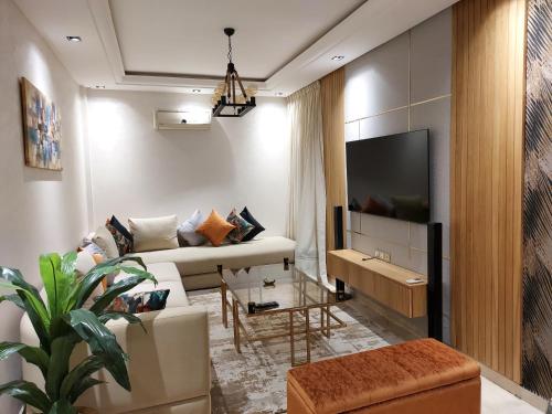 卡萨布兰卡luxury downtown apartment of 80m2 in front of Hassan 2 Mosquē and sea from family , pour famille , INTERDIT COUPLES ARAABIC NON MARIÉ, FORBIDDEN UNMARRIED ARAABIC COUPLES basement car park的带沙发和电视的客厅