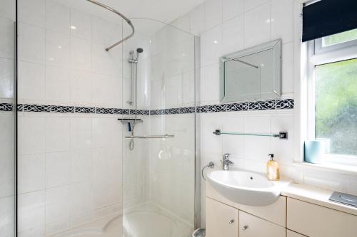 以撒港Highlands的带淋浴和盥洗盆的白色浴室