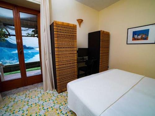 拉维罗萨尔瓦托雷住宿加早餐旅馆的卧室配有白色的床和窗户。