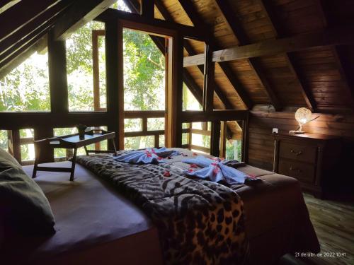 格拉玛多Cabanas dos Plátanos的小木屋内一间卧室配有一张豹床
