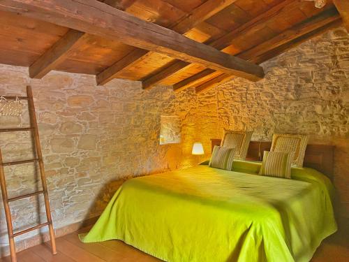 Nibbiano穆利诺伦提诺度假屋的一间卧室配有一张带两把椅子的绿色床