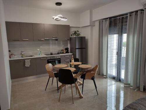 沃洛斯Grey Swan - Modern & Stylish apartment with Private Parking的厨房以及带桌椅的用餐室。