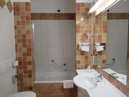 卡波利韦里TH Capoliveri - Grand Hotel Elba International的一间带水槽、淋浴和卫生间的浴室