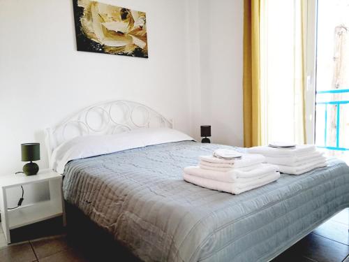 卡利塞亚-豪客迪克斯Kallithea Central Residence的卧室配有白色床和毛巾