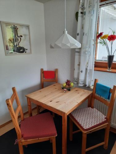 巴特黑雷纳尔布Ferienwohnung Am Wald的餐桌、两把椅子和一张木桌