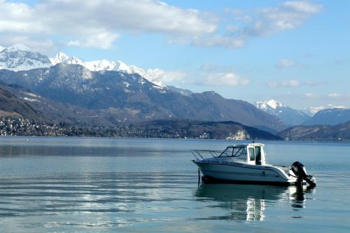 安锡Coeur d'Annecy, Idéalement situé的船在水中,背靠山