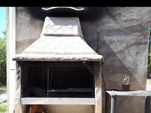 马拉圭Duplex "Valle Hermoso"的一个带屋顶和植物的户外烤箱