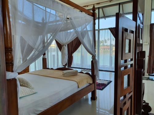 哥打巴鲁哥达巴鲁ALA河景度假屋的一间卧室配有双层床和窗户。