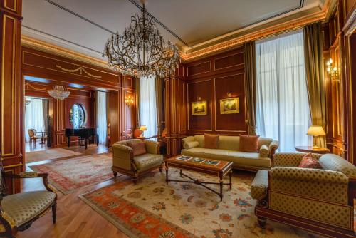 巴勒莫瓦格纳大酒店的客厅配有沙发、椅子和吊灯