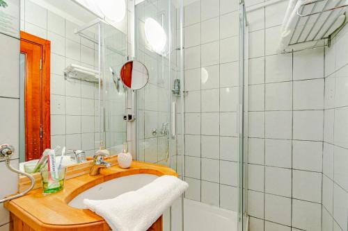 尼亚卢卡Hotel Dalmacija的一间带水槽和淋浴的浴室