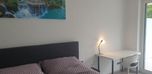巴德伊舍Gartenappartement Leonsberg的一间卧室配有一张床和一张带台灯的桌子