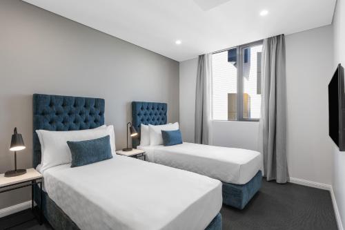 Meriton Suites Coward Street, Mascot客房内的一张或多张床位