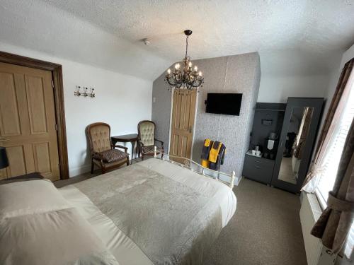 桑当Wight orchid island Hotel的卧室配有一张床和一张桌子及椅子