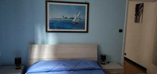 索里A due passi dal mare的卧室配有一张床,墙上挂着一幅画
