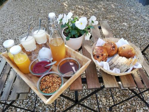 普罗丰德维耶La Roulotte du Herdal的一张野餐桌,上面有早餐食品和饮料