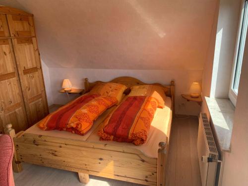 北滩岛Appartement Möhlkiek的一间卧室配有一张带两个枕头的木床