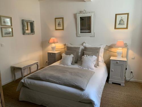 Saint-Girons-dʼAiguevivesLa Closeraie Saint Girons的一间卧室配有一张带2个床头柜的大型白色床